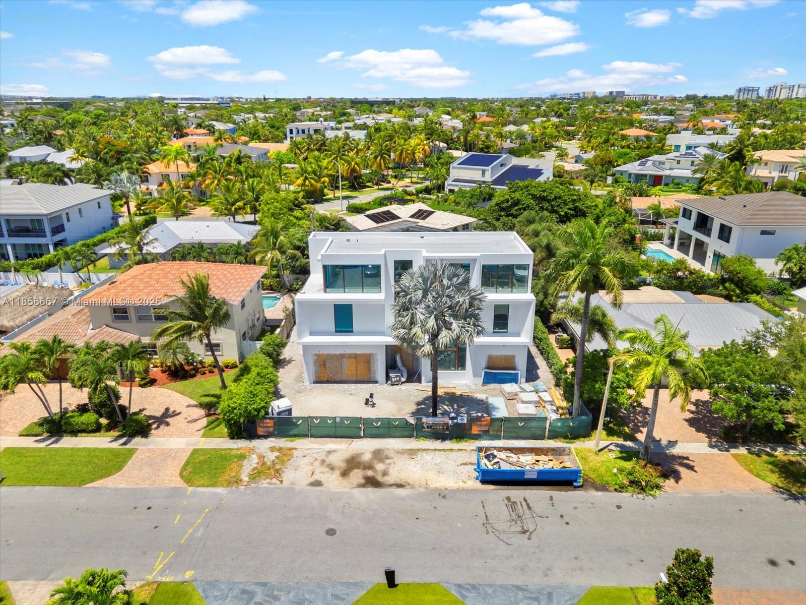 This exceptional, brand-new estate by Yacov Development Group defines modern luxury and architectural grandeur. Located in prestigious Boca Villas, this home offers resort-style living, beginning with a striking foyer with triple-height ceilings leading into an open-concept layout. Inside, five spacious bedrooms are complemented by a formal living room, dining room, office, and a gourmet chef’s kitchen with an adjacent prep kitchen for seamless culinary experiences. The third floor boasts a clubroom with a full bar and expansive open terrace, ideal for entertaining. An elevator provides access to all levels. The outdoor oasis includes a pool, covered patio, and gazebo with an outdoor summer kitchen. Located in exclusive East Boca Raton. November 2025 Completion.