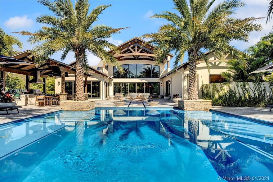 Nestled in one of the most exclusive neighborhoods in S Florida, this sprawling estate is situated on 2.35 manicured acres of ultra luxury living. Custom designed w/a professional interior designer, this mansion was meticulously and carefully brought to life with the highest craftsmanship throughout. An entertainers dream with an abundance of natural light, exquisite finishes round every corner. Gourmet kitchen, outside summer kitchen, resort-style pool/spa, guest house, separate solar paneled recreational building for RV's, cars & toys, an elevator leads you to the top floor with 3 entertainment areas for adults & kids. With 5,000+ add'l sq ft of paved entertaining outdoor space/cabana bath, complete home mgmt system, programmable lighting system, standby generator & more, it's turn key!