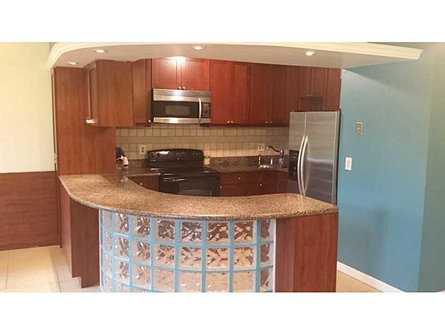 This substantially upgraded garden unit is move-in ready and has your name on the door. Unit features renovated kitchen & bathroom, tile flooring, washer/dryer in unit and new a/c unit (installed last year).The dark kitchen cabinets and granite styled cou nters make this a hidden gem. Enjoy the community pool which is only steps away from your front door. Looking for more ways to pass some time...walk across the street to the beautiful tennis & basketball courts or playground.