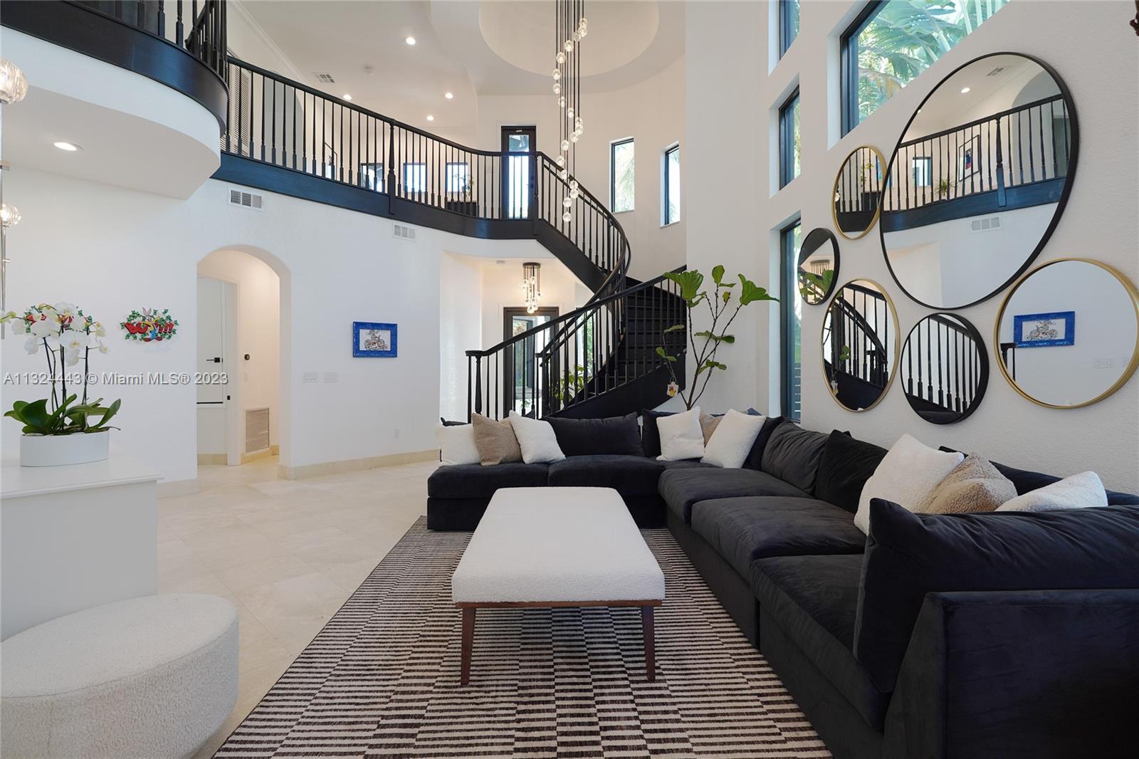 Beautifully remodeled 2 story Spanish Mediterranean home on prestigious La Gorce Drive. This residence boasts an open flow concept with 5 bedrooms, 4 bathrooms, formal and informal living spaces, 13ft ceiling heights, hardwood floors, an abundance of natural light, open eat-in kitchen, separate breakfast nook, & laundry room. The spacious primary bedroom features a private balcony overlooking the pool, walk-in closets, double vanity, and a large steam shower. Upgrades include new exterior lighting, impact doors & windows, pool heater, pool pump, sprinkler system, and more. A car collectors dream 4 car climate-controlled garage w/ garage lift. Private landscaped backyard offers a heated saltwater pool & spa perfect for entertaining.