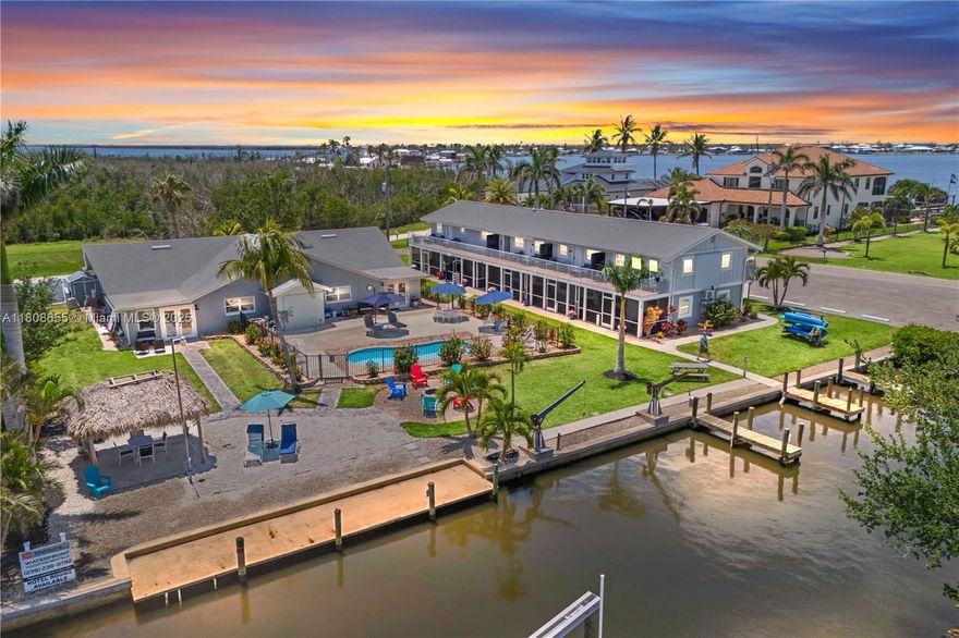 This waterfront boutique resort is located in Matlacha, a renowned old Florida art and fishing village with easy access to Cape Coral, Pine Island and the multiple surrounding islands - located directly on the Great Calusa Blueway - a 200 mile guided kayaking and paddling water trail. Total Units: 13 units plus one office. Two-story building: 9 units (2× 2BR, 6× 1BR, 1 hotel room currently used as laundry), Single-story building: 1× 3BR, 1× 2BR, 2 studios, Square Footage: 7,400 SF (4,650 SF + 2,750 SF), Land: 1 Acre, direct waterfront, Zoning: multi-family / hotel. Fully renovated in 2025 and each unit is spacious, with upscale decor and furnishings.