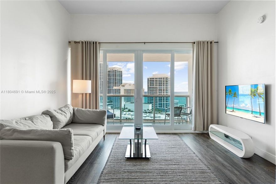 This fully remodeled top-floor condominium offers expansive ocean and city views through hurricane-rated impact sliding glass doors, complemented by 11-foot ceilings that enhance natural light and volume. The open-concept interior includes modern finishes, updated appliances, a built-in wine cooler, and recessed lighting throughout the kitchen and baths. Positioned within a full-service bayfront building that has completed its 40-year recertification, the property features premium amenities including a waterfront pool deck, fitness center, sauna, valet, and marina. A private enclosed garage and optional 40-foot dock slip provide added value. Conveniently located near the beach, retail, dining, and wellness facilities, with easy access to South Beach and Bal Harbour.