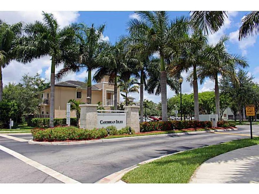 Caribbean Isles Condo 2/2 apartment offers a large 1200 sq. ft. of living space. This corner garden unit is full of light. The floors are all porcelain tile. Kitchen has been fully remodeled, with granite counter tops, tile back splash and first class app liances. Your private fenced patio yard is bordered by a lovely canal. Everything is in top condition. Live in Luxury community with all the amenities including a super sized pool and work out room in the clubhouse. Close to everything.