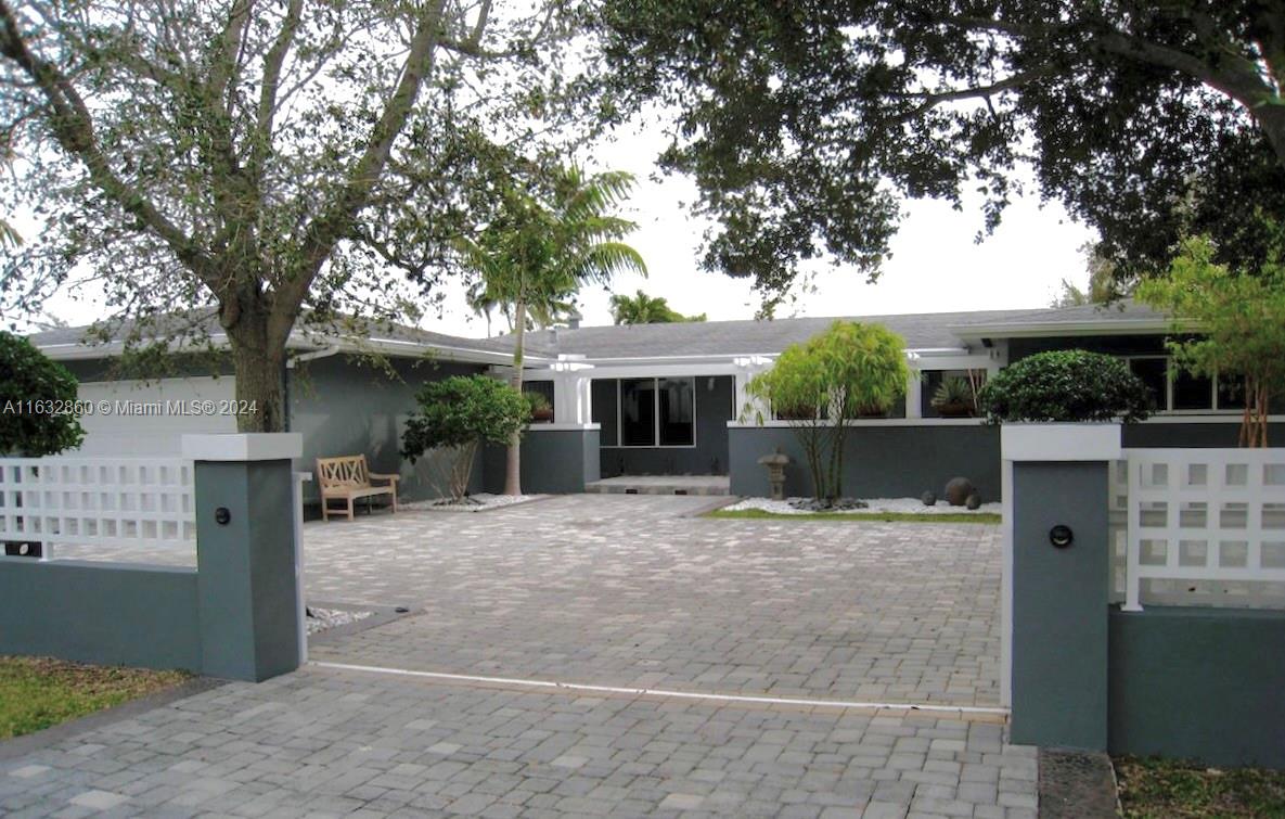 Walk to Pinecrest Elementary! Beautiful modern family home with 5 bdrms and 4 baths on a quiet street. Gated and tastefully landscaped with a cascading pond entrance. Great outdoor entertaining bbq area, open pool in a private setting. Hurricane safe with impact windows and full house generator. Brazilian cherry wood floors throughout, top of the line kitchen and bathrooms. 8 year old flat tile roof. Per building plan, living area = 2,619, adjusted area = 3,068 and total = 3,855 *** See Broker Remarks for Showing Instructions ***