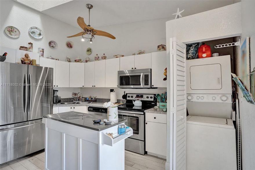 Charming 2-Bedroom 2 Bath, ALL AGES, PET FRIENDLY Villa with Modern Coastal Flair. Step into this stunning villa featuring a split floor plan for ultimate privacy. The bright white kitchen is equipped with stainless steel appliances and opens to a spacious living area with vaulted ceilings. Coastal-inspired tile floors flow throughout, complementing the airy ambiance. Both bathrooms have been tastefully updated, adding a touch of luxury. Enjoy the convenience of an in-unit washer and dryer. Relax on the screened patio, surrounded by tropical breezes. The villa boasts accordion hurricane shutters, a new roof, and access to a sparkling community pool. Perfectly situated near shopping, dining, and major highways, this home offers a serene yet connected lifestyle. Don't miss this gem! FHA/VA