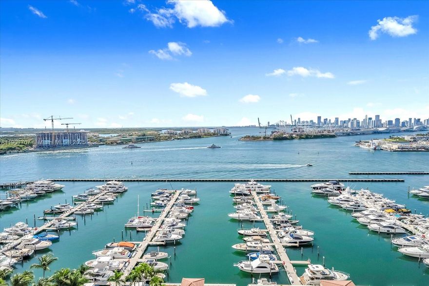 What a view ! Enjoy from both balconies the sunset and the sunrise. Most desirable line in the Yacht Club at Portofino. Unit has travertine flooring, floor to ceiling windows. Come live in the best neighborhood of Miami Beach. Walking distance to the beach and to the most exclusive restaurants in town. Heated pool and jacuzzi, state of the art gym, convenience store, tennis court and bbq area are awaiting you. The unit comes with 1 assigned space and 1 valet included. Washer/Dryer inside the unit.