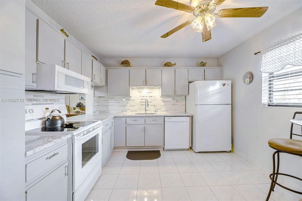 Photo of 4955 E Sabal Palm Blvd #305, Tamarac, FL 33319 (MLS # A11982710)
