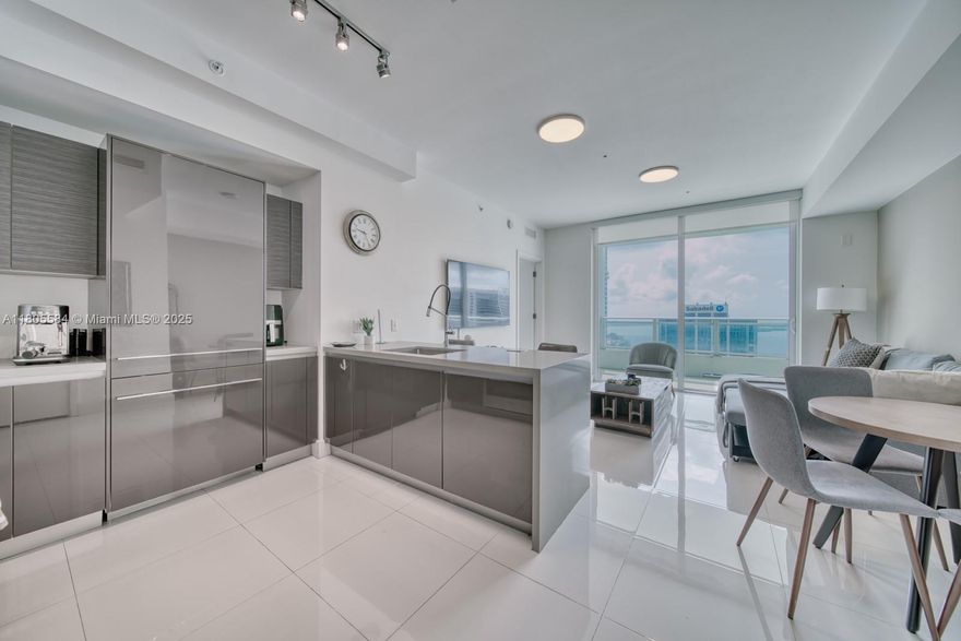 Located in the heart of Brickell, this contemporary 1-bedroom, 1.5-bathroom condominium at the luxurious Bond is a must-see. Residence 3802 includes expansive views of Biscayne Bay along with floor-to-ceiling windows, and has been meticulously upgraded to include an oversized walk-in closet, custom murphy bed / desk in Den with half bath, white porcelain flooring, and window treatments throughout. Kitchen features include a full suite of Bosch appliances, European style cabinetry and silestone countertops. The Bond boasts a Starbucks onsite, a fitness center, a spa with a sauna and steam room; an outdoor pool deck with cabanas and summer kitchens; a children's play room; and an executive business center. See 3D Tour!