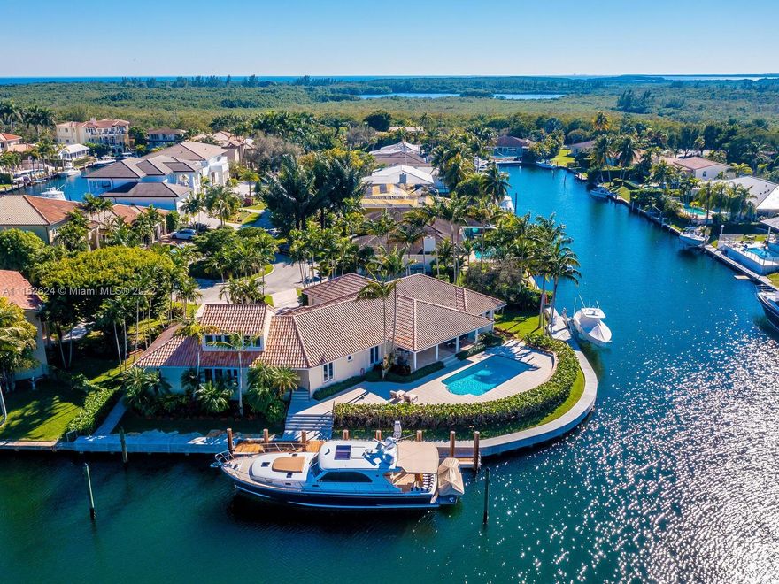 Serious boaters' home boasting 240' of prime water frontage on rarely avail 16k+ point lot in Gables by the Sea.  Resort-style covered terrace/pool & meticulously landscaped gardens overlook expansive waterway w/new, raised seawall, 11 new mooring pilings, 60' dock, 20k lb boat lift & dedicated AC yacht utility rm. Updated Tommy Bahama style 4BD 4BA 1971 home features main floor bedrooms w/2nd level Captain's office overlooking the wide turning basin for easy navigation of 90' yacht. 2-car gar, generator, alarm system/cameras, tv's/speakers, custom cabinetry.  Full impact doors/windows by La Finestra, 3-zone AC/s, separate laundry room & pantry, all PVC plumbing. Located in City Beautiful, Coral Gables w/access to the finest in schools, amenities and municipal services & neighborhood park.