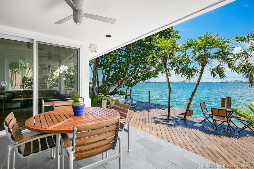 Located in guard-gated North Bay Island this 2-story, 4BR/4BA gem designed by Architect Barry Sugerman offers 70ft of sparkling waterfront facing the downtown Miami skyline w/open Biscayne Bay views. Mexican tile downstairs, carpet & bamboo floors upstairs, soaring ceilings, a wet bar, an office, spacious open living & dining area w/a custom wine cabinet. A large chef’s kitchen sports a breakfast area w/direct bay views. The 2nd floor principal suite features dual walk-in closets, dual bathrooms with direct access to a large terrace overlooking the bay. Outdoor highlights incl. a large bay-facing terrace to entertain w/summer kitchen, mature tropical landscaping, open seating areas, dock and a generator to power  entire home. There is also room to build a pool, subject to permit approval.