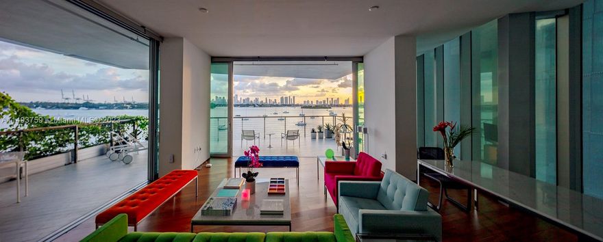 Perched above the bay, revel in the ever-changing Miami downtown skyline as seen across Miami Beach’s most beautiful Islands and Biscayne Bay.  This luxury condo, a creation of Pritzker Prize-winning architect Jean Nouvel, seamlessly blends indoor and outdoor living. With disappearing walls of glass, experience the sensory delight of reflections from water, light, and the surrounding islands. Enjoy the spectacle day and night on the covered private wrap-around terrace, running beyond the full length of this residence, this terrace is a rare find and one of the few offered in this building. This spectacular corner unit features 3 lg bedrooms, 3.5 baths, 2 parking spaces, and an electric car charging station adding convenience to this architectural masterpiece. A truly magnificent residence!