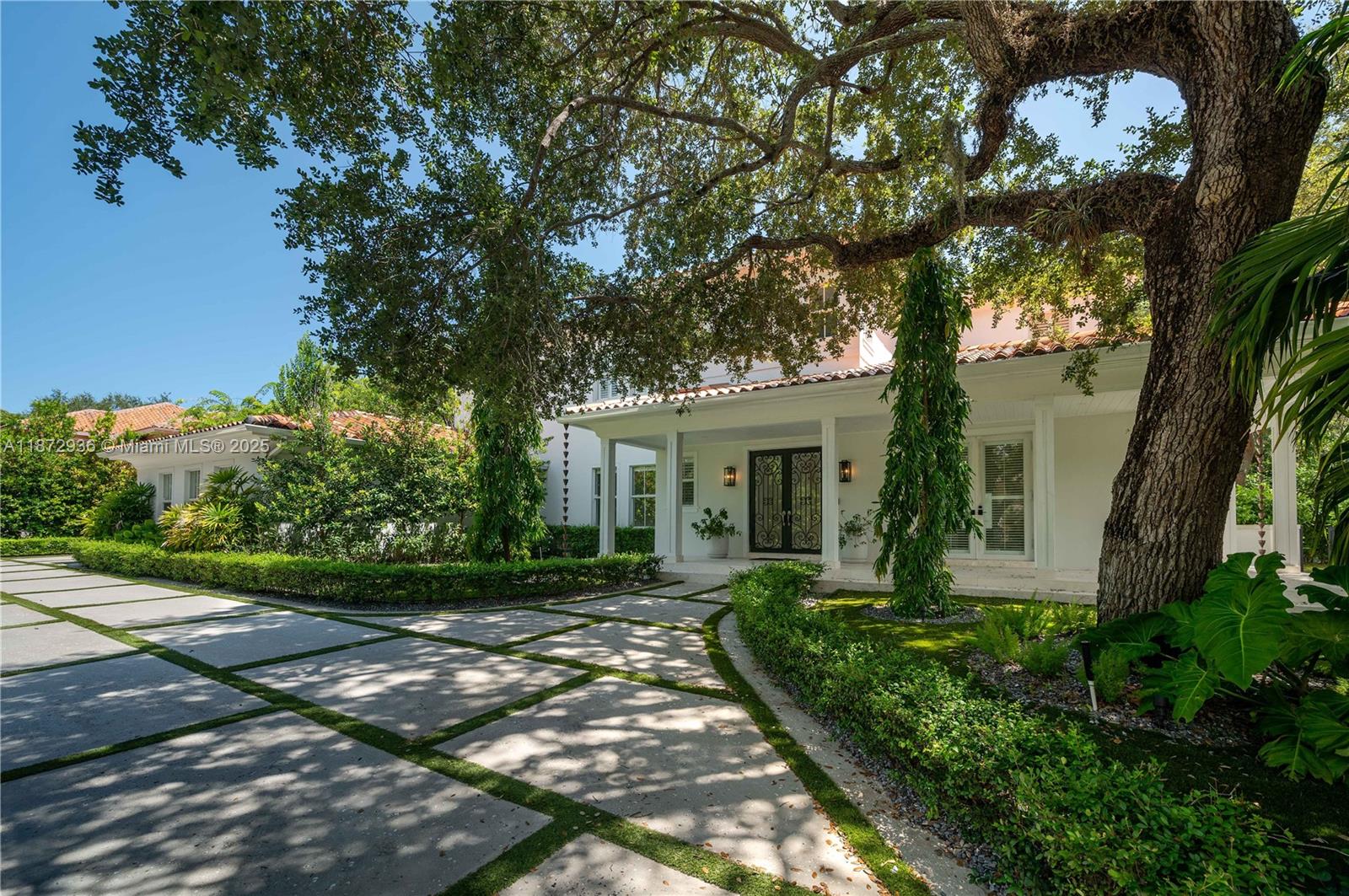 Welcome to this stunning and elegantly appointed residence nestled in Coral Gables’ prestigious Cutler Oaks Estates. This exceptional 7-bedroom, 6 bathrooms home offers 5,616 sq ft of refined living space on a generous 0.42-acre lot, thoughtfully designed for sophisticated family living and effortless entertaining. Discover a flowing layout with formal living and dining rooms, an inviting family room, and a gourmet kitchen with island, perfect for gatherings of all kinds. Rich tumbled marble floors, impact glass windows, and sleek finishes enhance every corner. Step through to your private garden oasis featuring the pool and lush landscaping. With a 2-car attached garage, circular driveway, and location near top-rated schools, parks, and all the best of Coral Gables!