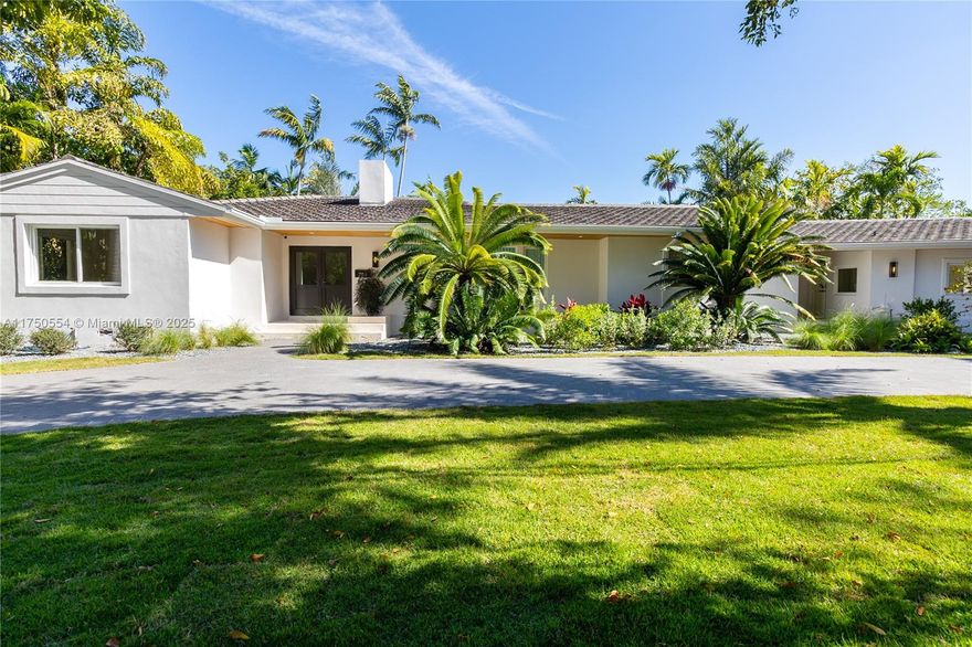 Experience luxury waterfront living in this exquisitely reimagined 4-bed, 4-bath Coral Gables estate. A grand foyer leads to an open, light-filled living area with impact windows, marble & wood floors, and a stunning fireplace. The chef’s kitchen, featuring top-tier appliances and a gas stove, seamlessly connects to the living, dining, and family rooms. The split-bedroom layout ensures privacy, while the staff quarters add versatility. Set on a 13,900 SF rectangular lot with 151 ft of waterfrontage, the property offers a separate pool area, lush gardens, and open yard space. A circular driveway, new roof, and mature landscaping enhance its elegance. Ideally located near top dining, shopping, and cultural spots, this is a rare opportunity to own a premier Coral Gables waterfront home.
