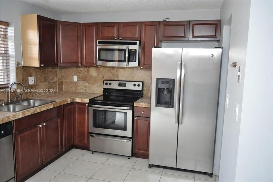 Excellent townhouse located in the highly desirable Terra Lake Villas community. This well-maintained residence features two spacious primary suites, stainless steel appliances, in-unit washer and dryer, a combination of tile and wood flooring, and accordion hurricane shutters. Enjoy a private, fenced patio with canal access, perfect for outdoor relaxation. One pet up to 20 lbs is permitted with a $200 non-refundable pet fee. Impeccably maintained and truly move-in ready. The owner is willing to accept the second-month deposit in installments.