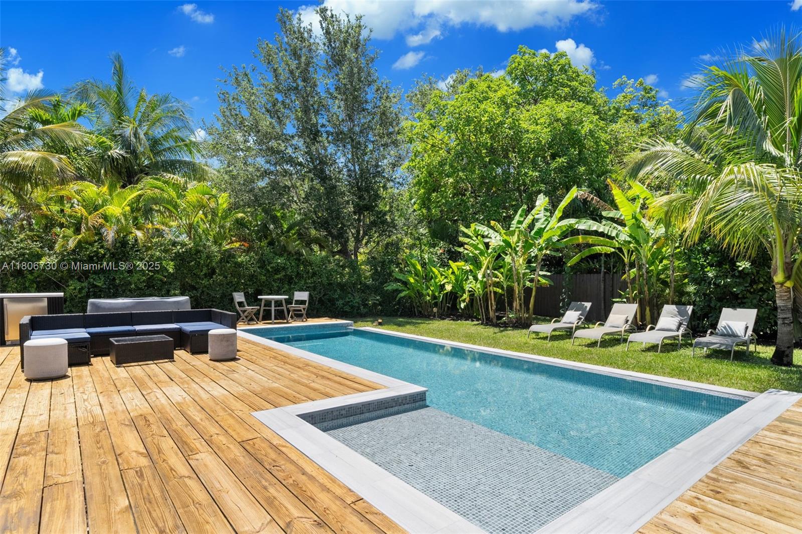 Prepare to be amazed by this 5 BED / 3.5 BATH pool home located in this quiet South Miami neighborhood on an oversized lot! Upon entering you are welcomed by a spacious living room and an open kitchen with cooking island, granite countertops, commercial stainless steel appliances & wooden cabinets boasting generous storage potential. Primary suite features a floor-to-ceiling tile shower. Fully fenced backyard with fruit trees, infinity pool, spa, wood deck and outdoor kitchen is your favorite spot to sip your coffee, sunbathe and enjoy gatherings with friends and family. Home has complete impact protection. Second living room with kitchenette ideal for guests! Solar panels with Tesla Batteries and a large storage container complete the offering. A Beautiful Miami Home! MAKE IT REIN!