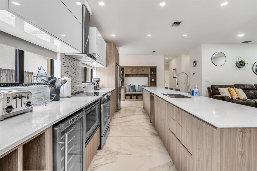 Modern design meets turnkey comfort in this stunning Croissant Park pool home with no HOA. Featuring impact windows/doors, 9' ceilings, porcelain floors, and PVC plank in bedrooms. Open layout with formal living/dining and an oversized family room overlooking the spacious backyard with a saltwater pool. European kitchen & bath cabinetry, quartz counters, custom bar, GE stainless appliances, wine cooler, and LG washer/dryer. Built-in expansive walk-in closets by Closet Factory & Closet Solutions. Conveniently located just 8 mins to Las Olas, Downtown Fort Lauderdale & airport; 10 mins to the beach. Fully licensed Airbnb—furnishings negotiable, making this home a truly move-in-ready opportunity for primary residence, second home, or income-producing vacation rental.