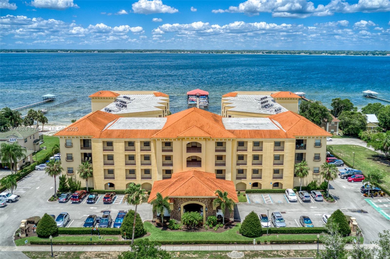 Discover refined living in this fully furnished resort-style condo, blending international charm with modern comfort. Set in an exclusive waterfront community on Lake Jackson, this residence showcases Mediterranean-inspired architecture and premium amenities. Residents enjoy a grand lobby, fitness center, waterfall-fed infinity pool, 36-slip marina, and 300 feet of private beach. The split floor plan features open living spaces and a balcony with lake and pool views. The primary suite offers dual walk-ins, dual vanities, Jacuzzi tub, and walk-in shower. Every detail enhances comfort and style. Located near historic downtown Sebring, you’ll find fine dining, boutique shopping, and natural beauty just moments away. A rare lakeside retreat.