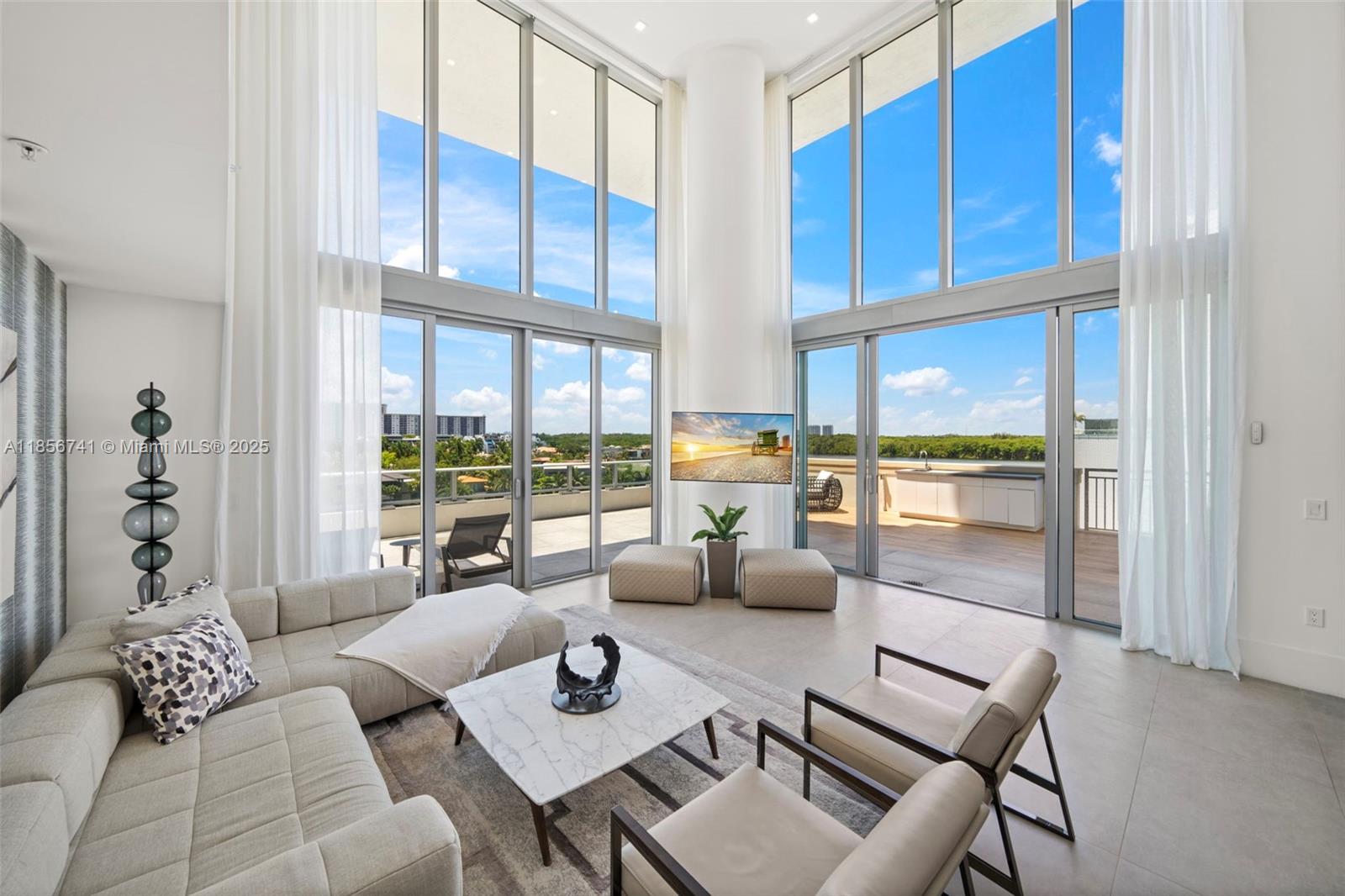 One-of-a-kind, two-level corner residence where light-filled interiors meet sleek modern design, and floor-to-ceiling windows frame incredible water views from every room. This residence offers 4 bedrooms, 4.5 baths, and a den that has been transformed into a private office. Two luxurious primary suites provide flexibility and privacy, one conveniently located on the first level and the other on the upper level. The gorgeous open Italian kitchen with quartz countertops flows seamlessly into the grand living room, creating the perfect space for entertaining. Enjoy your days barbecuing and sunbathing on the expansive wraparound terrace with your own private pool, outdoor shower, and endless water views. Residents also enjoy access to resort-like amenities.