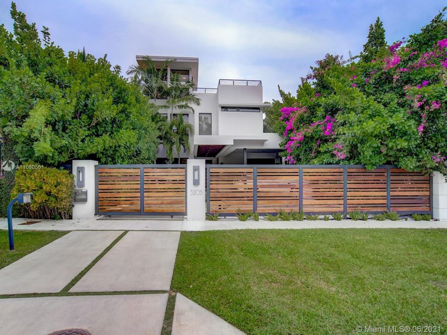 Located in the heart of North Coconut Grove, this gorgeous, gated modern home built in 2014 features 5BD/5.5BA with lofty 11’ ceilings. The home boasts high-end finishes throughout such as the MiaCucina kitchen, high impact windows and doors, versatile theatre room, roof top terrace, elevator and luxurious master suite with oversized walk-in closet and private lounge. Eastern exposure offers abundant sunlight to the lushly landscaped backyard featuring a heated pool, covered patio with full summer kitchen connecting back to the family room, kitchen and living room making this home ideal for inside/out entertaining. Complete with a three-car carport and whole-house generator. Located one block from Kennedy Park with walking/running/biking trails and all that Coconut Grove has to offer.