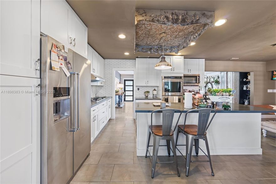 Waterfront living in Pembroke Lakes! This 3BD/2BA, 2,652 sq ft home with NO HOA sits on an oversized lot on the lake with breathtaking lake views. Enjoy a screened pool, outdoor kitchen, real wood-burning fireplace, impact windows, accordion shutters, and a 2021 roof. The modern kitchen features Red Dot KitchenAid appliances, a built-in coffee bar and large double car garage. The expansive rear addition, complete with its own mini-split AC, is large enough for a mother-in-law suite, studio, gym, or entertainment room overlooking the water.
Too many great features to list!!! Give me a call to tour this property! Near great schools, CB Smith Park, top malls, and major highways.