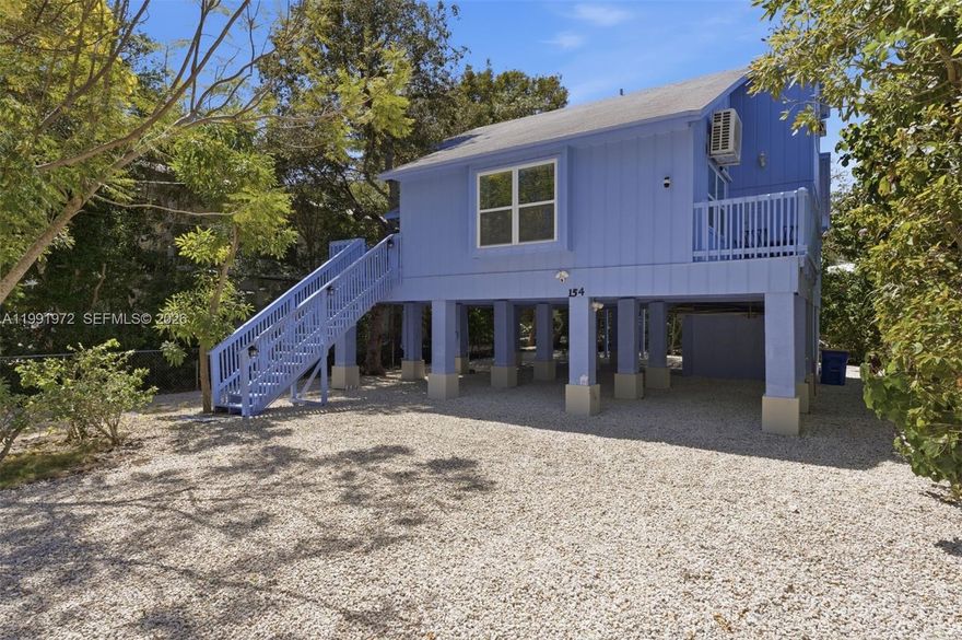 "Blue Haven" is a beautifully renovated elevated 2-story residence in the heart of Islamorada, offering the ideal blend of modern upgrades and relaxed Florida Keys living. This fully remodeled home features a vibrant blue exterior and a bright, contemporary interior designed for comfort and style. The home offers 3 bedrooms and 2.5 bathrooms, with nearly 1,700 square feet of interior living space complemented by expansive outdoor terraces perfect for entertaining or unwinding in the tropical breeze. Inside, you’ll find a brand-new kitchen with solid wood cabinets, quartz countertops, and stainless steel appliances. Additional upgrades include new vinyl flooring throughout, recessed lighting, fresh interior and exterior paint, and new split A/C units for efficient cooling. Partial impact windows provide added durability and peace of mind. The ground level offers generous open space with excellent potential for future development, storage, or the addition of a pool. Situated on a 6,600 sq ft lot, the property provides both flexibility and value in a prime location. A true Boater’s Paradise, residents have access to a private boat ramp available for just $150 per year. Being offered fully furnished and turnkey, this property is well-suited as a primary residence, vacation getaway, or income-producing rental. A rare opportunity in the heart of the Florida Keys.