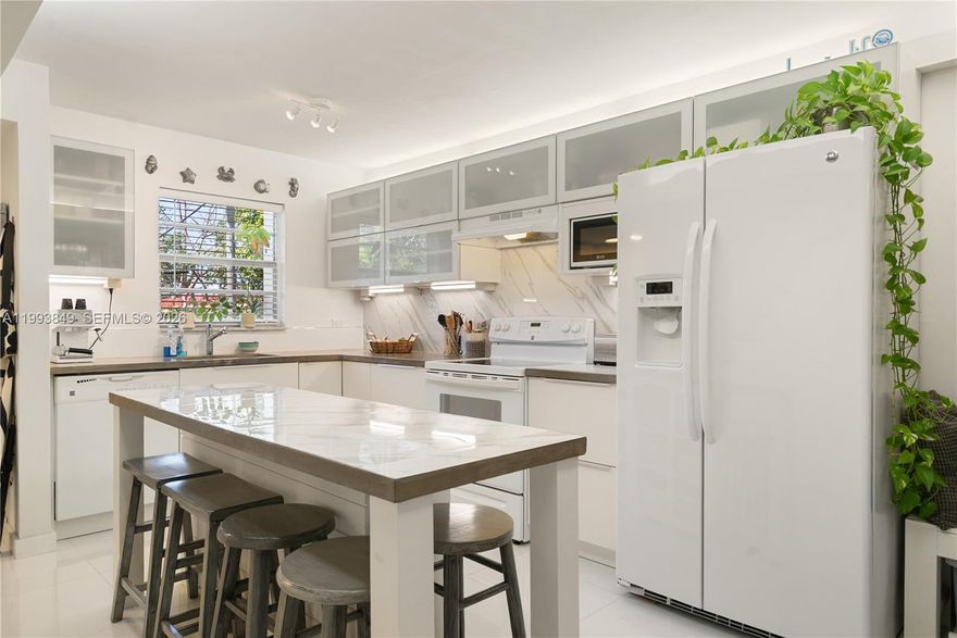 UNIQUE! Completely remodeled with a reworked floorplan to optimize space & functionality, this townhome is the crown jewel of the building! Welcome to Holiday by the Sea #26, a beautifully updated 2-bedroom, 2.5-bath townhome in the heart of Key Largo. Thoughtfully redesigned, this home offers a bright, open layout with modern finishes & efficient use of space throughout. The fully renovated kitchen features concrete countertops, island with bar seating, and flows seamlessly into the spacious living/dining area. A convenient half bath, under-stair storage, and a private balcony overlooking peaceful tropical hardwood hammock complete the main level. Upstairs, you'll find two generously sized bedrooms, each with its own en suite bath. Both bathrooms have been tastefully remodeled including transom-style windows for added natural light. A full-size washer/dryer are located on the 2nd floor for convenience. Each bedroom offers its own private balcony, ideal for enjoying your morning coffee & embracing the beauty of island living. With ample closet space & quality upgrades throughout, this turnkey townhome is just perfect. Centrally located at mm 100 in downtown Key Largo, you're just a short distance to Key Largo Harbor Marina, local restaurants including Skipper's, Conch House, Seaside Eatery, shopping, Key Largo Community Park, Jacob's Aquatic Center and more. Don't miss your chance to own a beautifully renovated home in one of the most desirable locations in the Florida Keys!