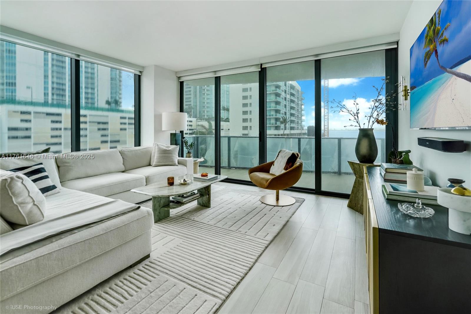 Rarely available corner unit with stunning bay views in Edgewater! This spacious 1,639 sq.ft. condo features 2 master bedrooms, each with walk-in closets and a private terrace, plus an enclosed den and 3 full bathrooms. Enjoy an abundance of natural light through floor-to-ceiling windows in this beautifully designed layout. One of the few units in Edgewater with 2 assigned parking spaces! Located in a prime Miami location, this residence offers luxury living at its finest