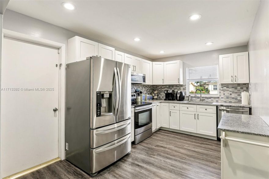 Cozy & UPDATED villa in desirable 55+ Delray Villas offers modern comfort and spacious open floor plan. This move in ready gem boasts new vinyl flooring, S/S appliances & completely updated kitchen & bathrooms, & IMPACT WINDOWS. Enjoy low electric bills w/ SOLAR PANELS(paid off by seller) powering the home, the privacy of split-bedrooms layout & rear screened porch overlooking the quiet yard & wetlands. Large primary bedroom offers walk in closet & "shower"-bathroom, & bathtub in 2nd bathroom. Spacious 1 car garage w/ a built-in EV CHARGING STATION—perfect for electric vehicle owners & dedicated laundry area w/ washer & dryer. Great location & low-maintenance living! Community offers a clubhouse, 2 swimming pools, exercise room, tennis courts, & is close to restaurants, shops, and TPK.