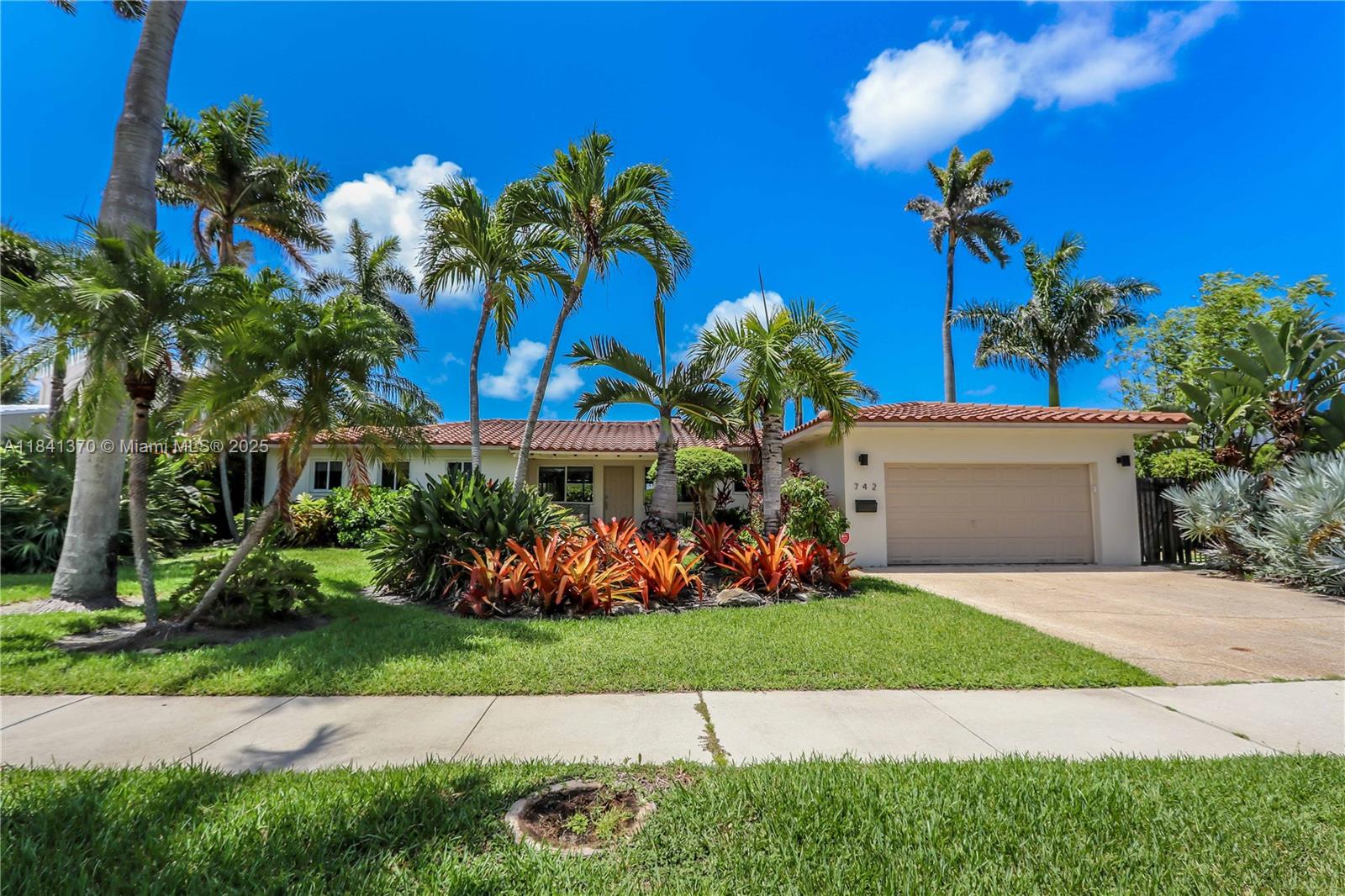 Magnificent location, 4 blocks from the beach & 1 block from South Lake, this beautiful 3 bed, 2.5 bath home sits on a rare 12,737 sq ft double lot with tropical landscaping & a large, stunning gazebo—perfect for entertaining. Enjoy an open floor plan with porcelain tile throughout, impact windows & doors, and a spacious kitchen w/ exotic midnight blue granite waterfall counters, Bosch appliances, ample cabinetry, & a bar pass-through. The home features a formal dining room, eat-in sized kitchen, family room, laundry room, & 2-car garage. Split layout, w/ a primary suite showcasing a mosaic & travertine tile glass-enclosed shower. The second full bath continues the coastal charm with mosaic tile, a glass shower, & separate soaking tub. Move-in ready & designed for relaxed coastal living.