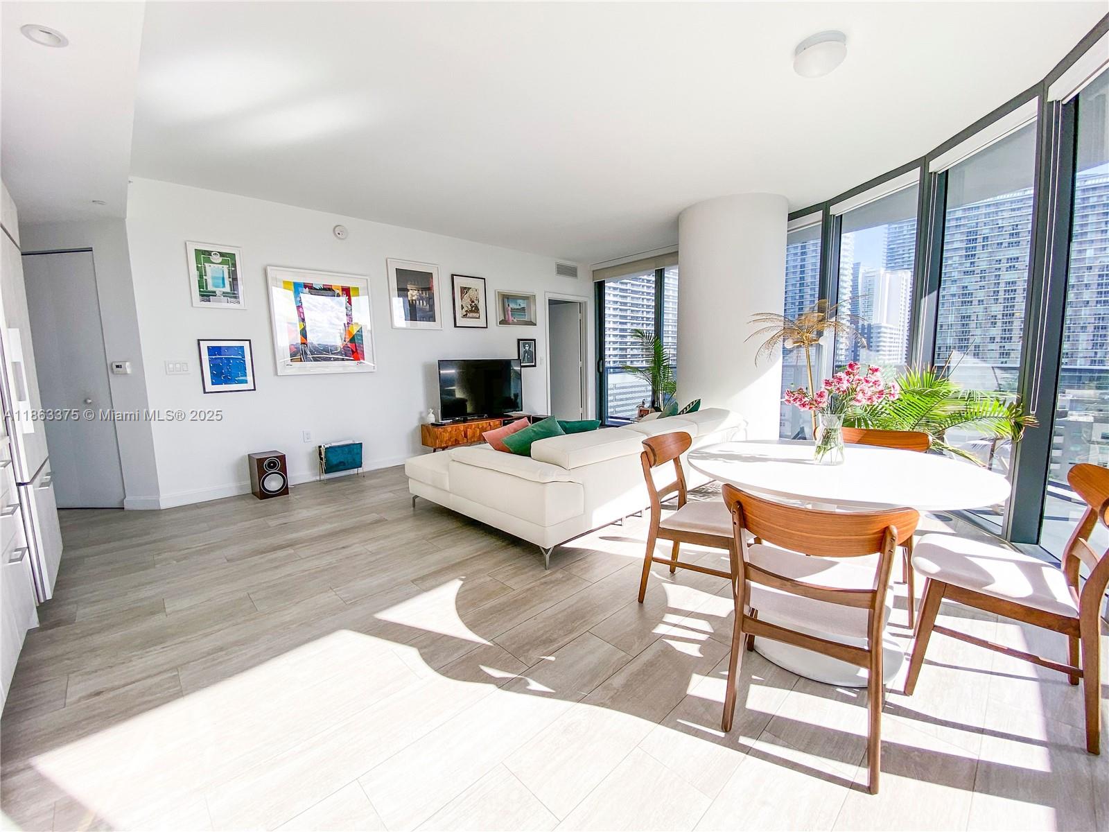 Experience modern city living in the heart of Brickell! This stunning corner unit offers incredible natural light, floor-to-ceiling windows, and beautiful views that highlight the vibrant energy of Miami. The open layout features hardwood floors throughout and a sleek kitchen with high-end appliances, creating a stylish and comfortable space. Enjoy stunning views and the elegance of the building’s unique rounded architecture. Residents have access to resort-style amenities including two pools, jacuzzi, spa, gym, cinema room, and more across two levels. Perfectly located steps from Brickell City Centre, Mary Brickell Village, Publix, and top restaurants. Water, WiFi, cable, and one assigned covered parking space are included, making this an ideal home or investment opportunity.