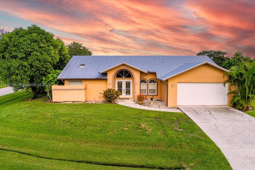 Welcome to this charming 3-bedroom, 2-bath home in Port St. Lucie, offering comfort and peace of mind with a new metal roof, full impact windows and doors, an A/C from 2019 and water heater from 2022. Featuring a blend of tile and carpet flooring, this home includes a full-size washer and dryer for convenience, high ceilings and skylights. No HOA or vehicle restrictions. Enjoy the spacious screened porch overlooking a large backyard with mature fruit trees—perfect for relaxing or entertaining. Don’t miss this move-in ready home with plenty of space both inside and out!