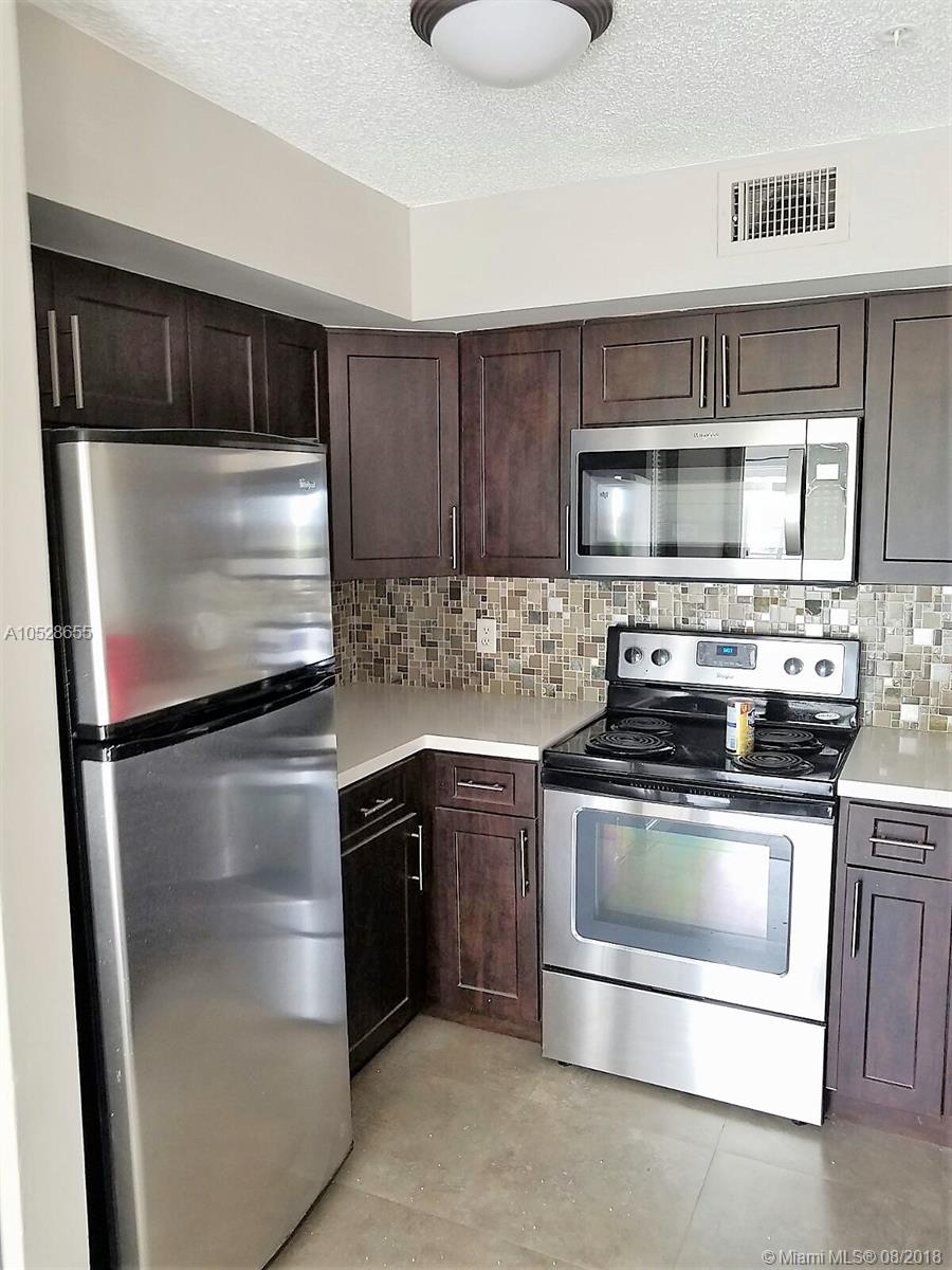 COMPLETELY REMODELED! NEW KITCHEN(DARK BROWN CABINETS, GLASS TILE BACKSPLASH, WHITE QUARTZ! COUNTERS, SS APPLIANCES). NEW TILE FLOORS IN THE KITCHEN AND DARK BROWN ENGINEERED WOOD IN ALL COMMON AREAS AND BEDROOMS. NEW BATHROOM CABINETS W/WHITE QUARTZ COUNTERS & GLASS BOWL SINK. POOL, SPA, TENNIS, GYM, RACQUETBALL