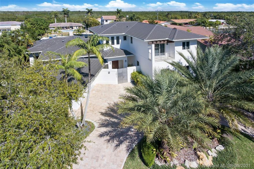 Boater's dream-completely rebuilt in 2013 contemporary 2-story, gated community "Gables by the Sea". 100ft dock, no bridges to the ocean, 10-12ft ceiling, high-end appliances (Miele, Wolf, Sub-Zero, Gaggenau), ItalKraft kitchen cabinets, gorgeous finishes, maid's quarters, barbeque, heated pool, 2-car garage, plenty of storage, high impact windows, 5 en-suit bedrooms, 7 full bathrooms, den with built-in library, ADT security system, community park.