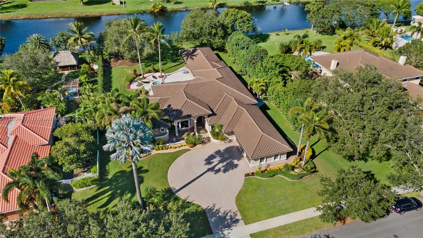 A great opportunity to own one of South Florida's premiere properties inside the gated and exclusive community of Westridge in Davie. This home is a luxurious and spacious home, with over 3/4-acre lote and spectacular water view. Featuring 7 bedrooms, 6 full baths, large garage for 3 cars and a roundabout with space for another 8 cars, spacious backyard, high celling's (new roof in 2020) and abundant light throughout. Primary suite with ample walk-in closets a grand hallway and contemporary renovated bathroom, Children's and guest wing with spacious rooms with beautiful bathrooms, living spaces perfect for entertaining, a formal and casual dining room, grand family room, main Kitchen and laundry room. Guesthouse with private entry, 2 bedrooms, 2 bath, kitchen, and a laundry room.