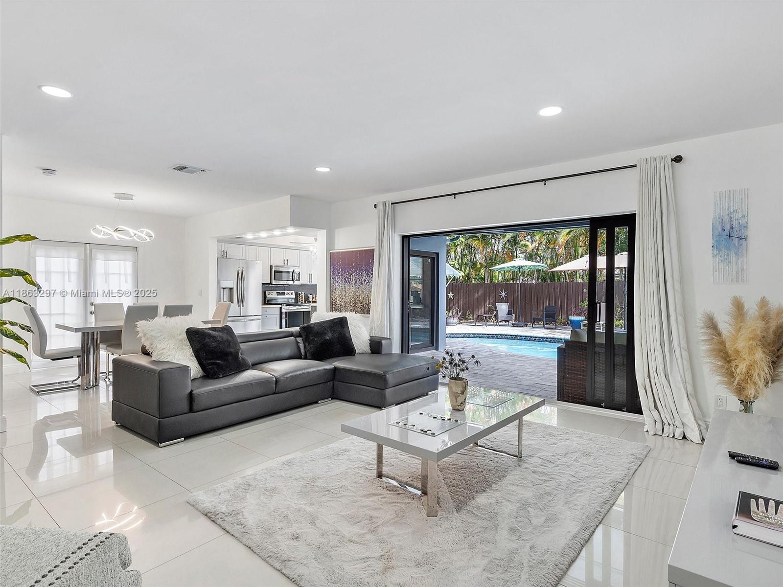Discover your private tropical oasis in the sought-after Imperial Point neighborhood of Fort Lauderdale! This fully renovated and tastefully furnished 4-bedroom, 2-bath residence boasts an open-concept design filled with natural light, sleek tile flooring, Corian countertops, and stainless steel appliances. Outside, indulge in resort-style living with a heated pool, pergola, cabana bath, outdoor shower, and expansive covered patio, which is perfect for entertaining or relaxing. Additional highlights include keyless entry, premium furnishings (3 queens + 1 king), and a fully stocked kitchen. Ideally located just minutes to the beach, Las Olas, Wilton Manors, Flagler Village, fine dining, shopping, and the airport.