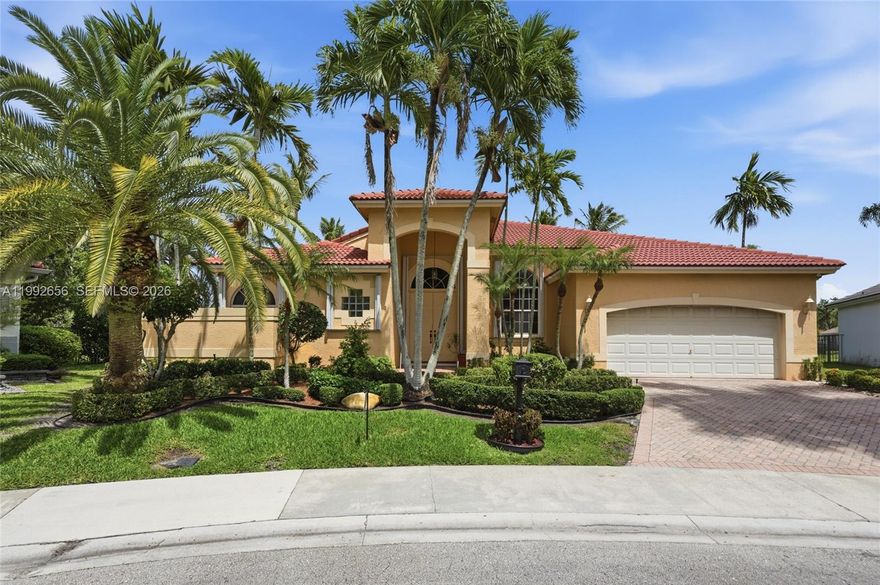 First time on the market in Weston Hills Country Club, this oversized lakefront home on an expansive cul-de-sac lot offers exceptional space, privacy, and endless potential in one of Weston’s most sought-after communities. Featuring 5 bedrooms and 4 baths in a desirable split-floor plan, the layout is ideal for both comfortable family living and entertaining. A spacious family room with a wet bar and wood-burning fireplace adds warmth and character, creating a true focal point for gatherings. Step outside to a heated pool and jacuzzi overlooking tranquil lake views, surrounded by lush tropical landscaping with mature mango, date, and coconut trees that create your own private retreat. The screened pool enclosure allows for year-round enjoyment, while a cabana bath, full accordion hurricane protection, neutral décor, and paver driveway add everyday convenience. A rare opportunity to customize a premier property in an outstanding location.