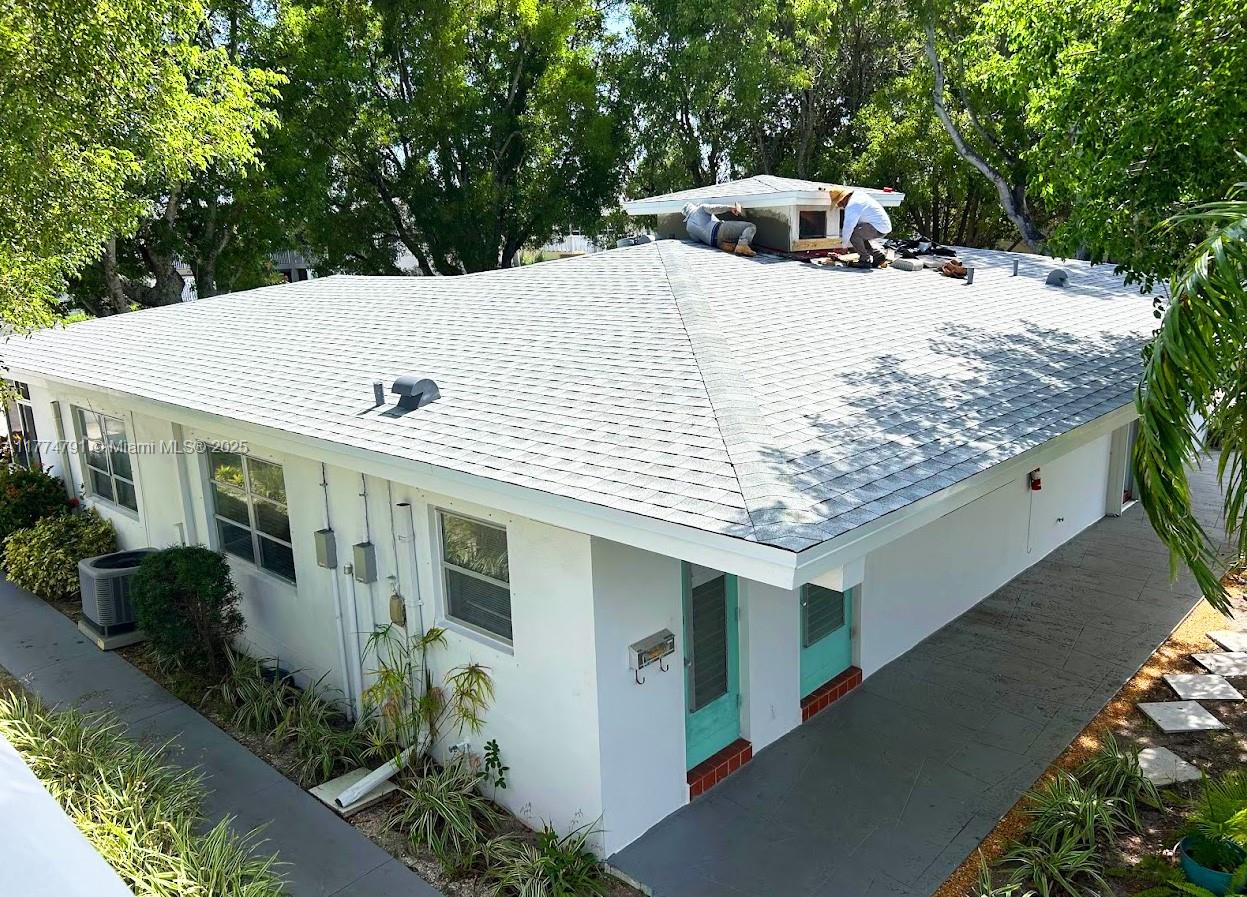 NEW ROOF. New electrical box. 40 and 50 years inspections passed. All-ages community. Spacious corner unit Villa feels like a private house with a garden, just a few steps away from a clubhouse and pool. Lots of natural light. No carpets - only tile floors. Private patio. Granite countertops. Ample storage space. Walk-in closet. Hurricane accordion shutters. Water usage, high-speed Internet, and cable TV included in the HOA. Amenities: updated clubhouse with Internet, heated salt pool, a new BBQ area, pickleball courts, community events and friendly neighbors, new laundry facilities, a lush, well-maintained green oasis area, and more!