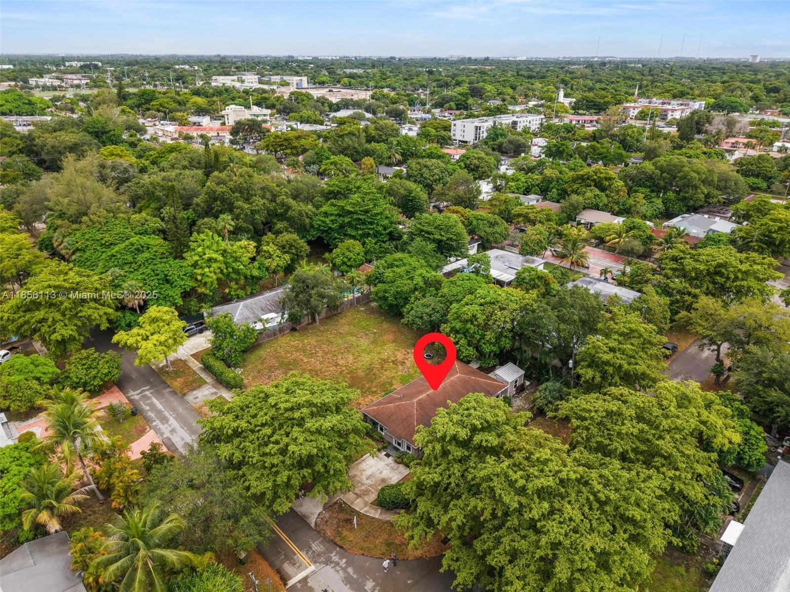 Exceptional 2019 home on an expansive 18,600 sqft corner lot, designed for comfortable living and effortless style. An open floor plan filled with natural light from hurricane-impact windows connects spacious living and dining areas to a sleek kitchen with high-end appliances, including a glass cooktop and dishwasher. Three generously sized bedrooms and two thoughtfully designed bathrooms offer comfort and privacy, while inside laundry adds convenience. Step outside to a patio and yard framed by mango and avocado trees, creating a peaceful, tropical setting to enjoy year-round. A detached backyard structure provides versatile space for a studio, guest space, or workspace. Ideally located in North Miami with quick access to Oleta River State Park, Biscayne Blvd, and local dining.