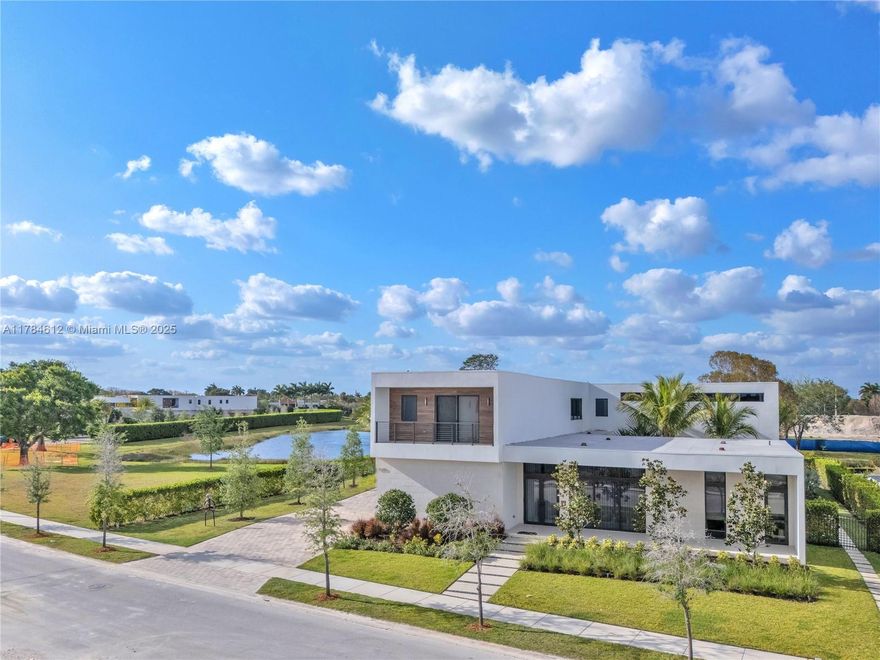 Welcome to the Modified O3A Model Residence at Botaniko Weston—a stunning embodiment of modern-era grandeur, offering over 6,000 sq. ft. of refined living space in one of South Florida's most exclusive enclaves.
This architectural masterpiece, a unique collaboration featuring the visionary design of Chad Oppenheim and the whimsical elegance of MacKenzie-Childs style, is nothing short of breathtaking. Every detail has been meticulously curated to elevate everyday living into an art form. With five ensuite bedrooms, six and a half bathrooms, a private media room, executive office, maid’s quarters, and a spacious three-car garage, this residence is designed to inspire. The chef’s kitchen stuns with an oversized quartz island, and top-tier appliances. With over half an acre land, pool and spa