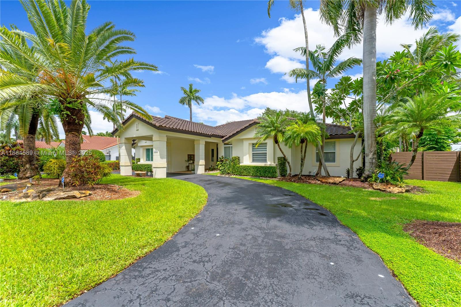 Discover this exceptional property located in the luxurious gated community of Poinciana Gardens. Enjoy a private retreat with a designer pool, enhanced by a striking rock waterfall. The meticulously landscaped, oversized backyard offers the perfect blend of modern luxury and comfort in true Miami living style. This 4-bed, 3-bath home features sun-filled living spaces. The primary bedroom is set in a split floor plan with a bathroom featuring a walk-in shower, a walk-in closet, and a beautiful view of the pool. On the opposite side, you’ll find 3 additional bedrooms — one of which includes its own private bath, walk-in closet, and direct access to the patio. Impact doors and windows.Roof from 2017. Two-car garage with automatic door opener,abundant storage space, and separate laundry room.
