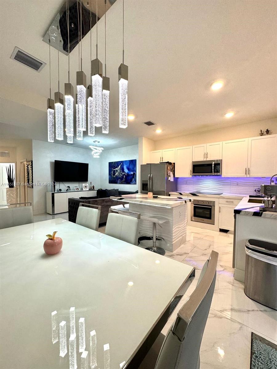 Welcome to this 3 bed/3 bath SMART townhome in The Riviera, one of Homestead's newest & most exclusive communities. This rare Bandol model, conveniently features a bedroom & full bathroom on 1st floor. Beautiful open concept with chef's kitchen featuring a center island quartz counter top, custom cabinets & new stainless steel appliances. Located on a premium lot with a larger covered backyard. ACCORDION SHUTTERS & ZEBRA BLINDS on all windows. All wired with OPTIC CABLE for maximum high speed internet. Washer & dryer included. Tank-less water heater. The luxurious resort style clubhouse features a pool with cabanas, jacuzzi & a full gym! Located near Baptist Hospital, Homestead Air Reserve Base & Turkey Point. Easy access to the turnpike. Full of upgrades. this home is a MUST SEE!