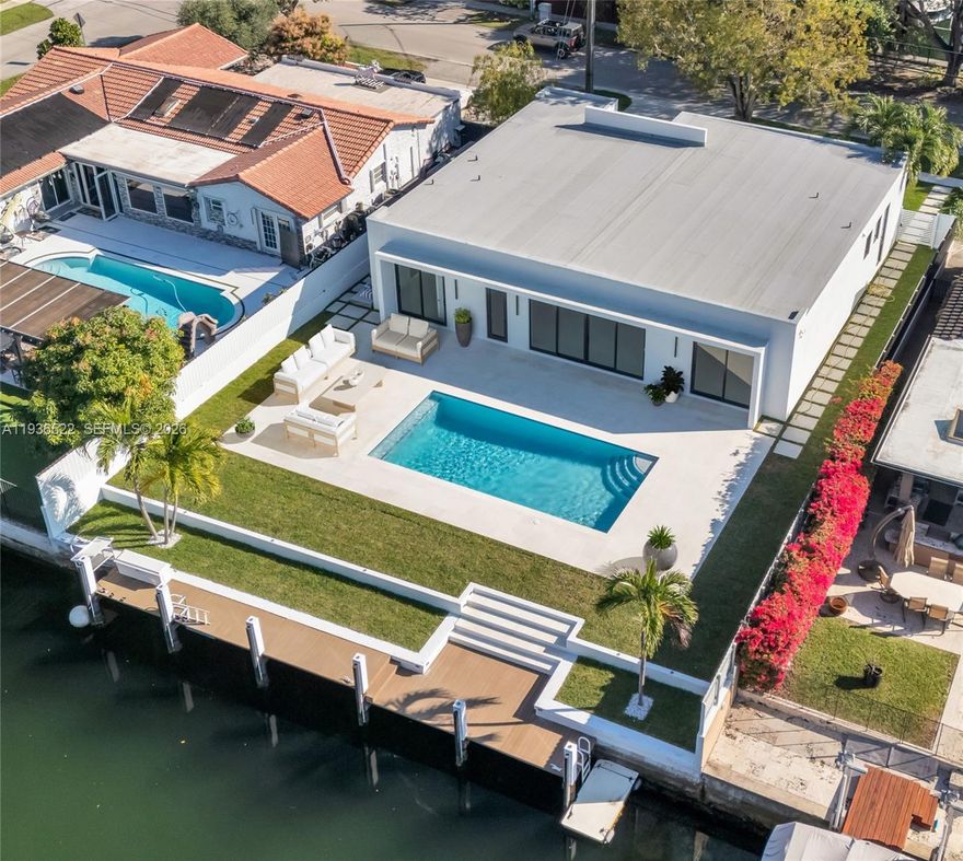 Experience modern waterfront living in this stunning 4-bedroom, 3.5-bath contemporary home located in the exclusive, guard-gated community of Keystone Point. Spanning over 3,000 sq ft, this beautifully designed residence was completely rebuilt and restored as a new construction while preserving portions of the original structure to maintain the favorable tax base. The home features soaring 12-ft ceilings, an open-concept layout, a chef’s kitchen with premium finishes, and built-out closets throughout. Seamless indoor-outdoor flow leads to a resort-style backyard with a sleek pool, updated dock, and a spacious open patio perfect for entertaining. With 75 feet of waterfront and direct ocean access with no fixed bridges, this home is a boater’s dream. Every detail reflects luxury, comfort, and the elegance of South Florida living. Just minutes from Bal Harbour Shops and 30 minutes from both Miami and Fort Lauderdale airports. Move-in ready and designed for those who expect more from life on the water.