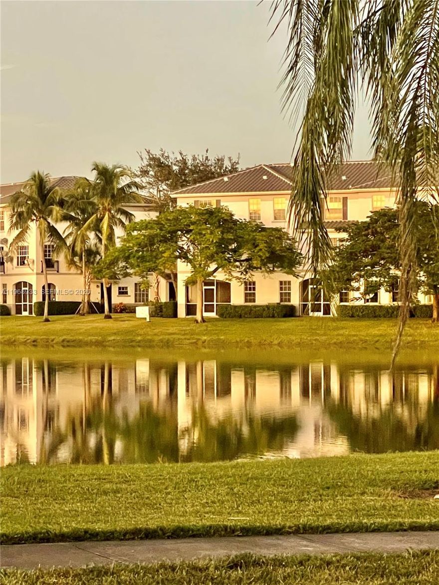 Investor’s dream with serene water views from this spacious 2-bedroom, 2-bath first-floor corner unit featuring a private porch perfect for relaxing. Rarely available attached garage plus two assigned parking spaces offer exceptional convenience and added value. The home features an open eat-in kitchen, generous living and dining area, and a full in-unit laundry room with full-size washer and dryer. Enjoy resort-style amenities including a pool, spa, and fitness center, all just minutes from major highways, shopping, and dining. 30-day association approval required. Vacant and easy to show.