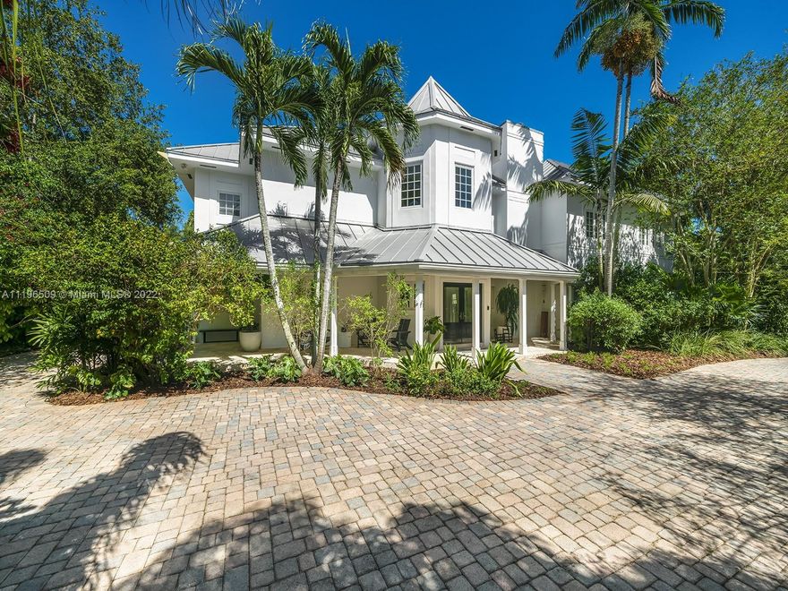 Stunning Key West Style home situated in heart of N Pinecrest, commanding a premium picturesque lushly landscaped lot. Elegant & stately residence, completely remodeled w/sophistication & infused w/modern zest. Discover a welcoming foyer, volume ceilings & an expansive flrplan. Desirable formal living rm, elevator, family rm, dining rm & home office. Fabulous chef’s kit featuring Miele/SubZero appl, breakfast area & wet bar. Enjoy an upstairs gathering space, lavish master w/sitting area, soaking tub, 2 WIC, huge decked terrace & 3 ensuite bedrms. Indulge in a spectacular resort-style outdr entertaining, w/covered patio, wet bar, half Olympic size pool, exotic fruit trees & an oversized yd. Add’l features: gym/office/storage rm, imp win/drs, metal rf, 40 solar panels, 2 car gar & carport.