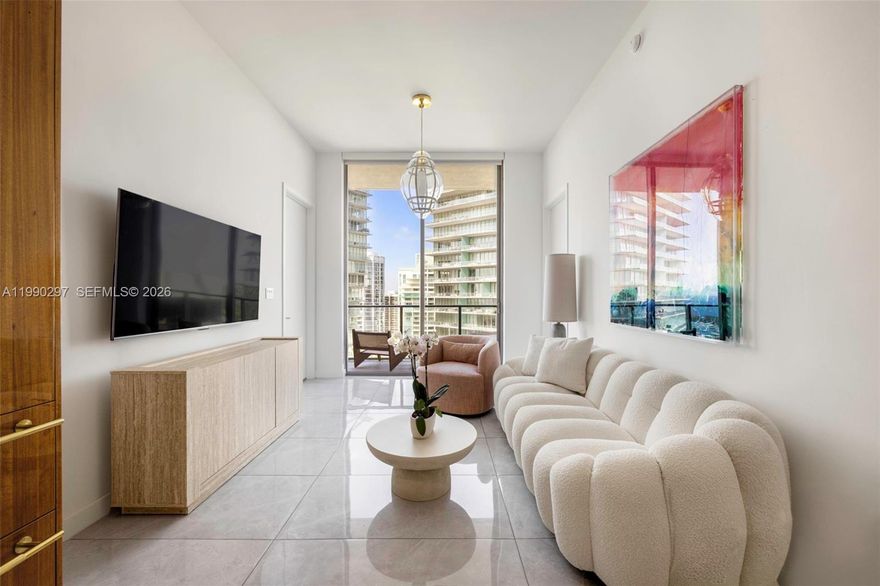 A refined residence at Mr. C Residences, offering elevated living in the heart of Coconut Grove. This 2-bedroom, 2-bath home features 1,046 sq ft of open, light-filled interiors with 11-ft floor-to-ceiling windows and seamless indoor-outdoor flow to a 170 sq ft private terrace and wraparound balcony with sweeping water and city views. The Italian kitchen is appointed with terrazzo quartz countertops and Wolf appliances, complemented by marble and European porcelain floors, solid core doors, and yacht-inspired detailing throughout. Residents enjoy resort-style amenities, a renowned in-building restaurant, 24-hour concierge, and full-service lifestyle management, all within a meticulously maintained building just moments from parks, marinas, the yacht club, and top-rated schools.