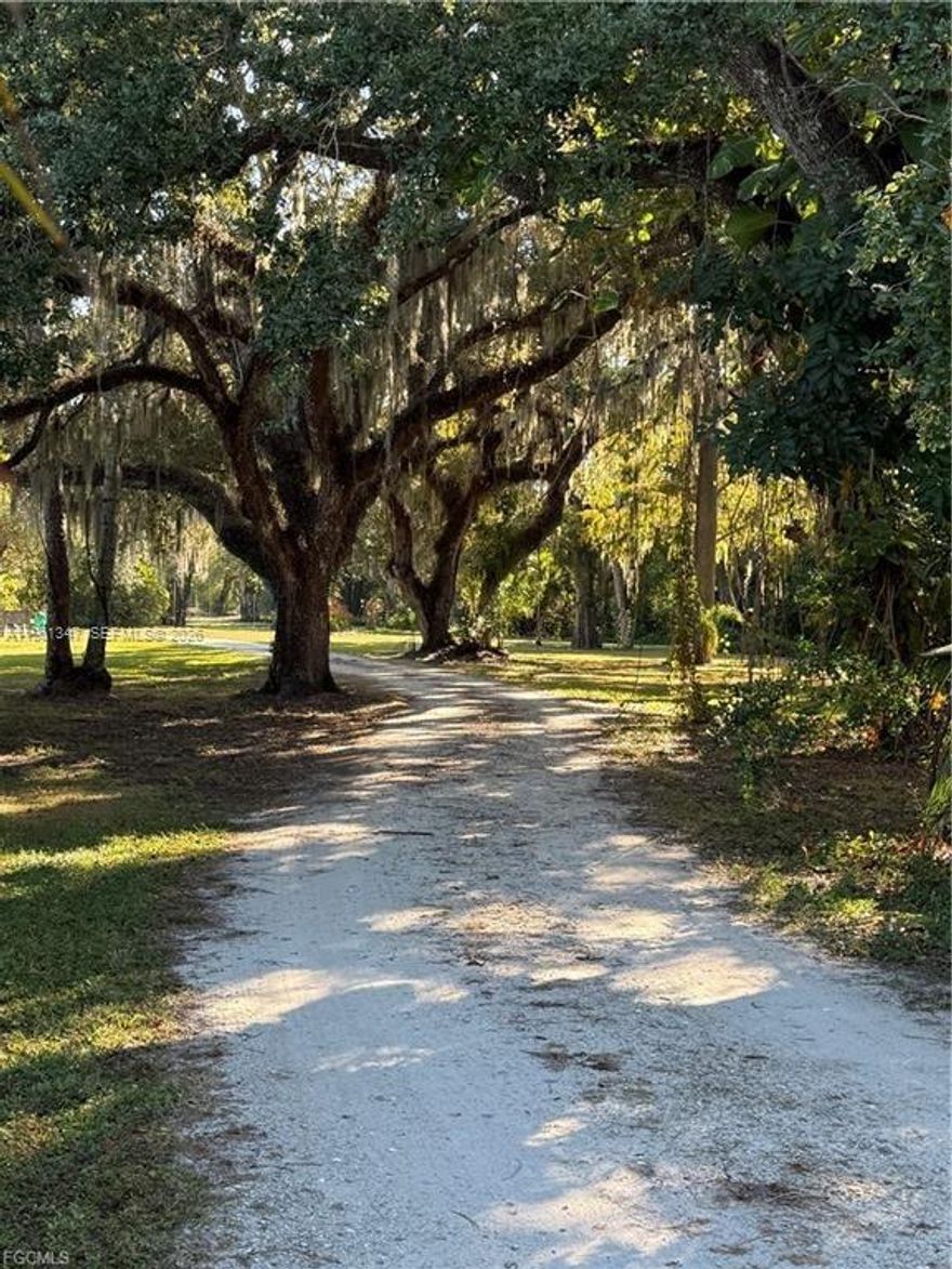 Located just a block east of the Cape Coral city limits and south of Pine Island Road (SR 78), this unique 5.17-acre property in North Fort Myers. The land consists of three connected parcels—14611 Smokey Hollow Lane, 14630 Smokey Hollow Lane, and 1345 Barrett Road—providing a rare opportunity for residential, agricultural, and storage uses. A secluded private drive nearly 900 feet long leads you to the main homesite, surrounded by nature and mature Florida landscape. The property features a small pond, an active creek, and a charming wooden bridge connecting to the westernmost section of the land.1345 Barrett Road (~3 acres, AG-2 zoning) • Excellent road-frontage potential • Formerly operated as a plant nursery • On-site well with standing sprinkler irrigation • Includes a house currently used for storage (not livable in current condition). 14630 Smokey Hollow Lane (~2,000 sq. ft. home) • 2-story residence built in 1991, • 3 bedrooms / 3 bathrooms, • New roof and fresh interior and exterior paint, • New air conditioner ready for installation, • Newer appliances except dishwasher, • Well water with Kinetic filtration system. 14611 Smokey Hollow Lane, • Large metal barn• Additional pole barn• Wooden bridge over the creek providing access to the west side of the property. This property is a rare find—over 5 acres of agricultural-zoned land with multiple structures, modern updates, unparalleled privacy, and an ideal location.