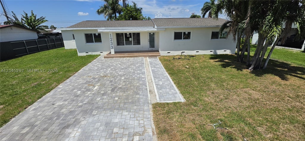 Photo of 1233 SW Avenue C Pl, Belle Glade, FL 33430 (MLS # A12045207)