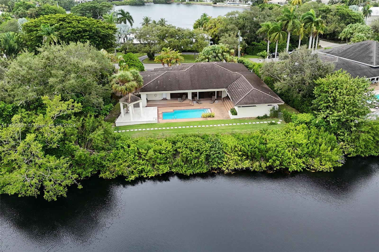Custom one-story home built in 1980 with idyllic lake views in the exclusive guard gated community of Hammock Oaks. Great floor plan perfect for families and fun. Huge open entertaining spaces with high ceilings overlooking the lake. Spacious primary suite with connected office/den and walk-in closet. Utility room off kitchen with separate large pantry/storage. Whole house Generac generator. Newer ACs. Pinecrest A+ schools. Excellent opportunity to renovate a great house in an exclusive guard gated community.