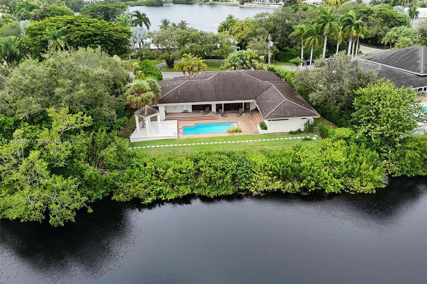 Custom one-story home built in 1980 with idyllic lake views in the exclusive guard gated community of Hammock Oaks. Great floor plan perfect for families and fun. Huge open entertaining spaces with high ceilings overlooking the lake. Spacious primary suite with connected office/den and walk-in closet. Utility room off kitchen with separate large pantry/storage. Whole house Generac generator. Newer ACs. Pinecrest A+ schools. Excellent opportunity to renovate a great house in an exclusive guard gated community.