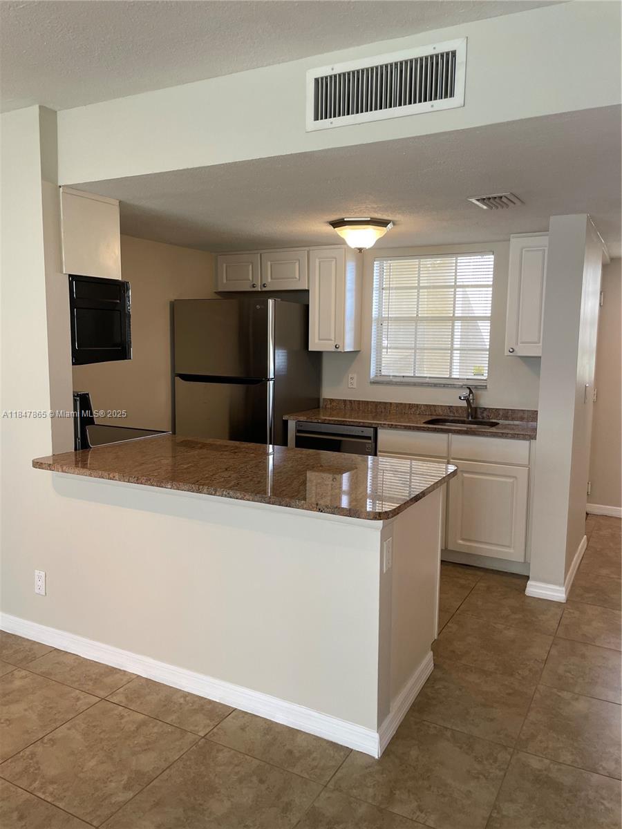 Feel right at home in this beautiful first floor apartment! 2 bedroom 2 bath with no carpet offering a spacious open floor plan with tile throughout the main living area and laminate floors in both bedrooms. The kitchen is open and overlooks the living area and has granite countertops and stainless steal appliances. The living area has large French windows letting lots of light in. This apartment has 2 assigned parking spaces one of which is a covered car port. Water, sewer, and trash included!!! HOA can rush the application process for a small fee if needed. First, Last, and Security Required! Please provide proof of income and credit report with all offers. This beautiful apartment won't last long!